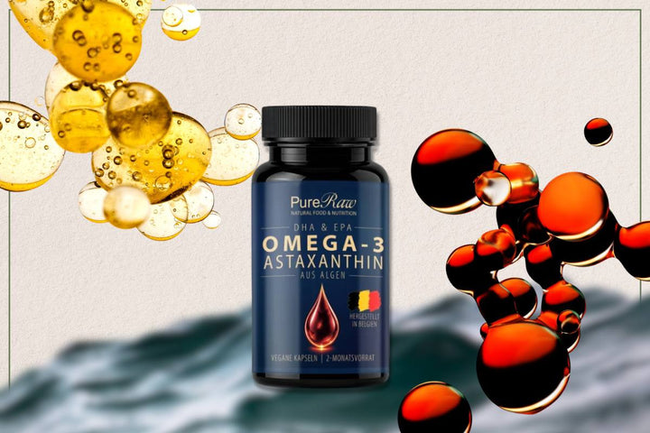 PureRaw Omega-3 plus Astaxanthin aus Algen in schwarzer UV-Schutz-Dose, umgeben von goldenen und rötlichen Öltropfen.