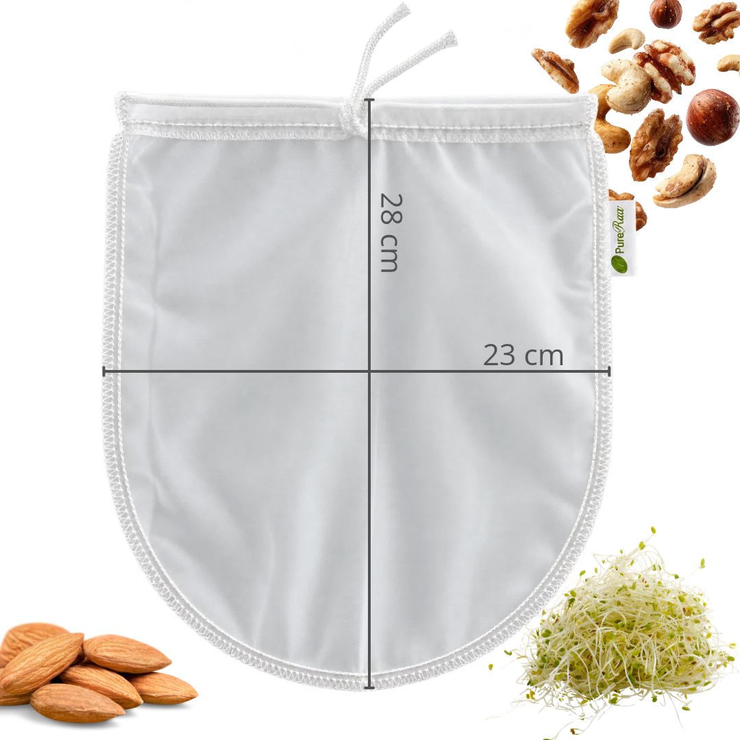 Maßgrafik: PureRaw Nussmilchbeutel mit abgerundetem Boden und eingezeichneten Maßen von 23 cm Breite und 28 cm Höhe, umgeben von Nüssen und Sprossen.
